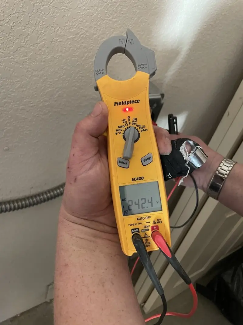 Voltage testing with clamp meter during Outlet Installation in Day Valley